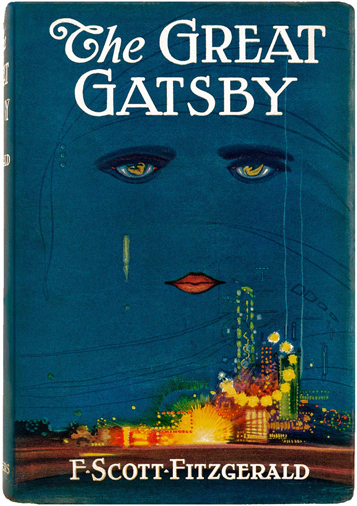 1925 cover of The Great Gatsby. Two disembodied eyes and a pair of red lips float in a deep blue sky above an indistinct brightly-lit city skyline