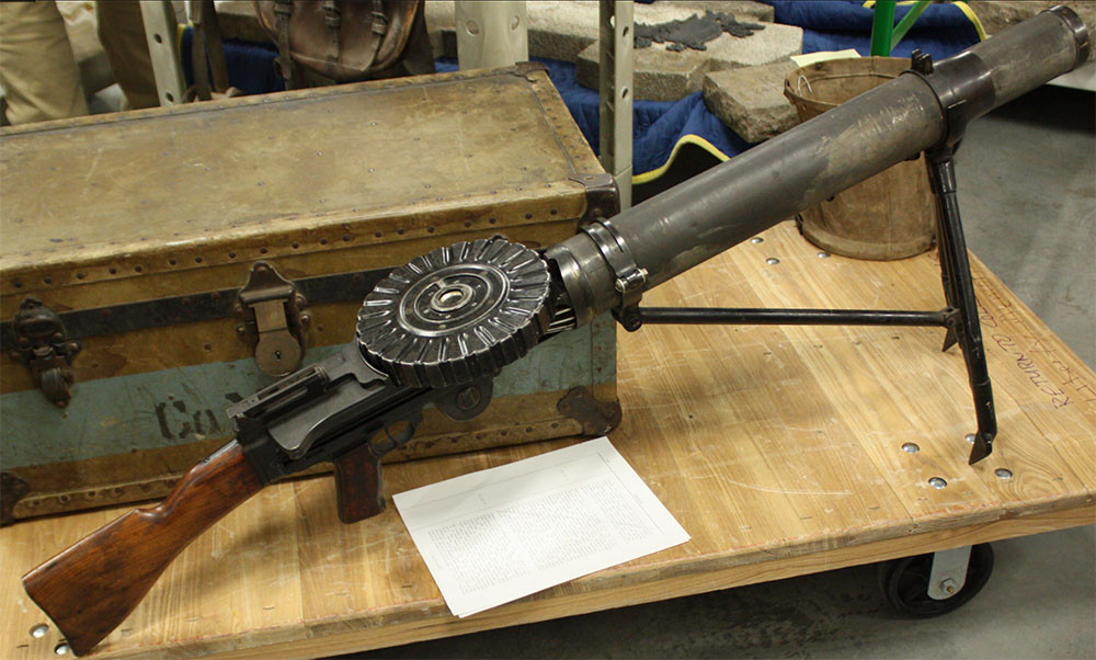 Modern photo of a WWI Lewis machine gun set up on a monopod on a rolling pallet