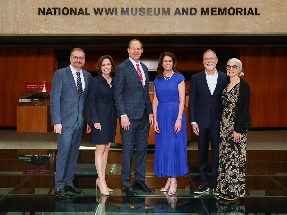 Modern group photo of three white men in suits and three white women in dresses