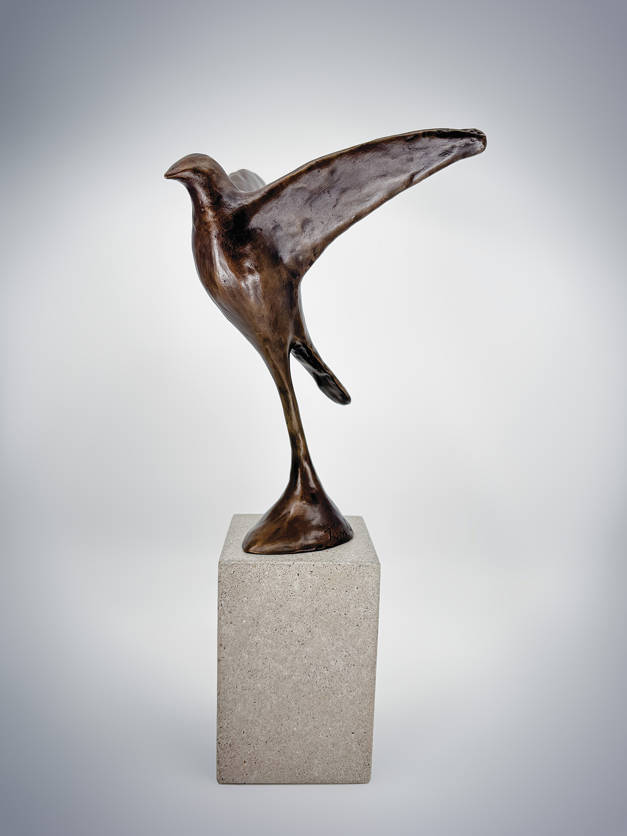 Trophy consisting of a cast bronze bird in flight mounted on a stone base